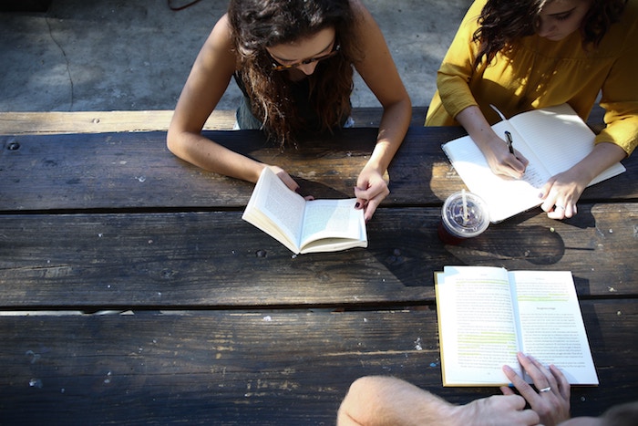 Friends studying at a picnic bench